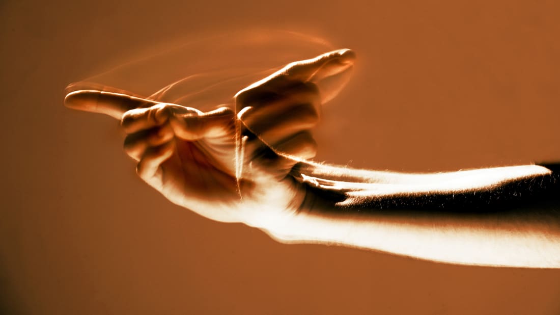 A person signs "welcome" in American sign language.