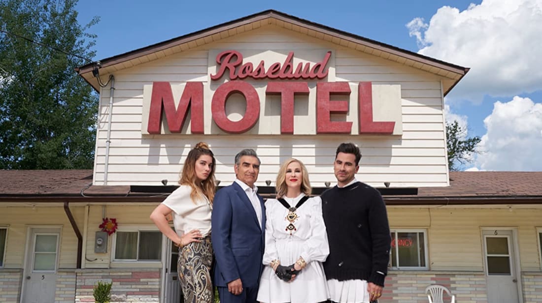 Annie Murphy, Eugene Levy, Catherine O'Hara, and Dan Levy pose outside the Rosebud Motel on Schitt's Creek.