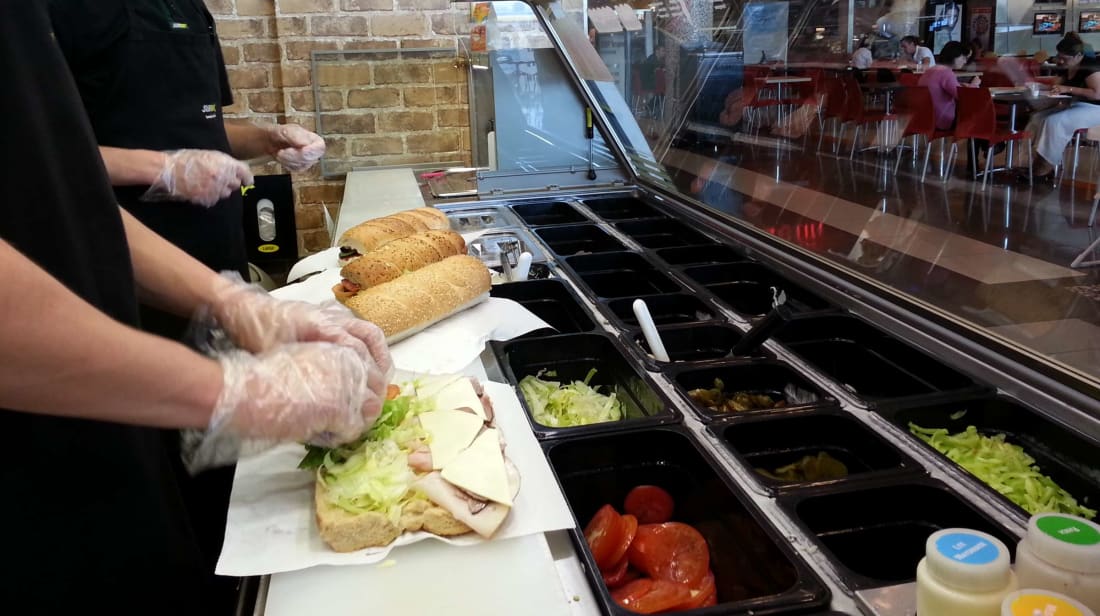 Just a couple of Subway employees making dessert.