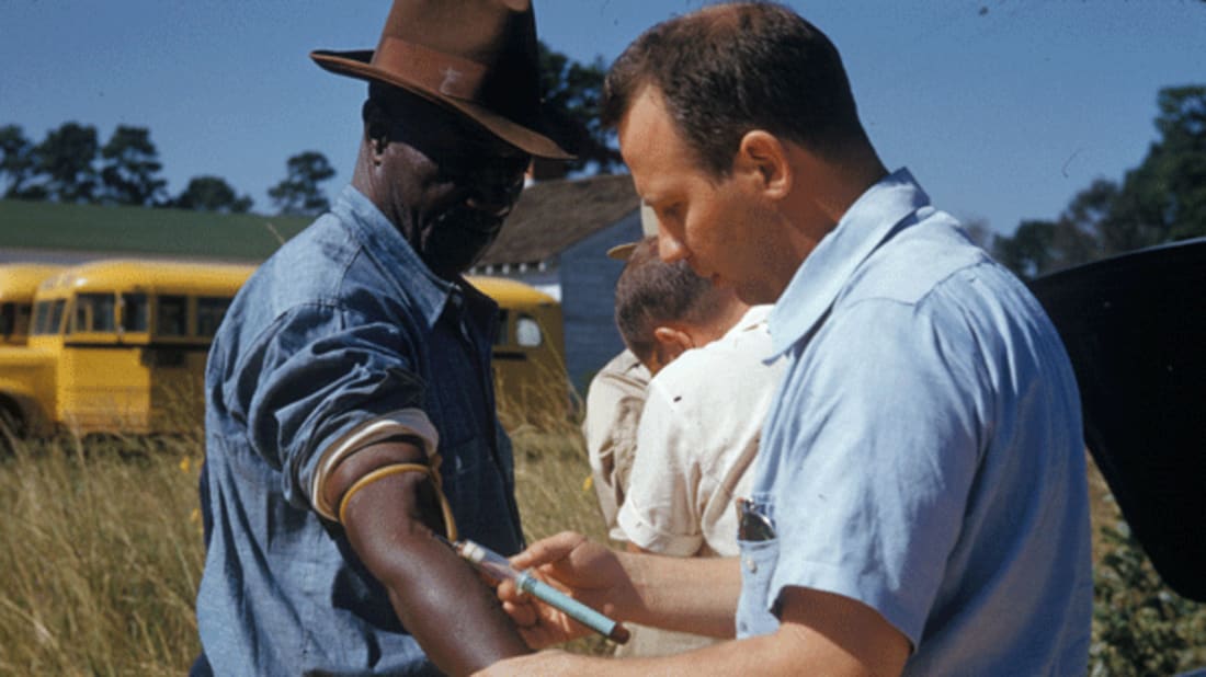 A doctor draws blood from one of the study’s subjects.