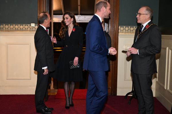 Kate wore a black dress which she teamed with pearl drop earrings and a quilted Chanel handbag. 