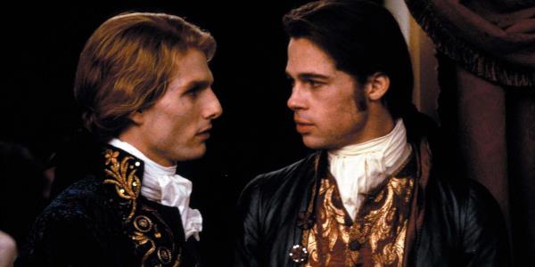 Tom Cruise as Lestat and Brad Pitt as Louis look at each other in Interview with the Vampire